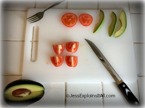 tomato and avocado on a cutting board