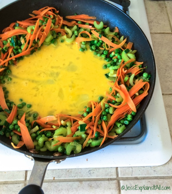 eggs in the center of a pan of vegetables