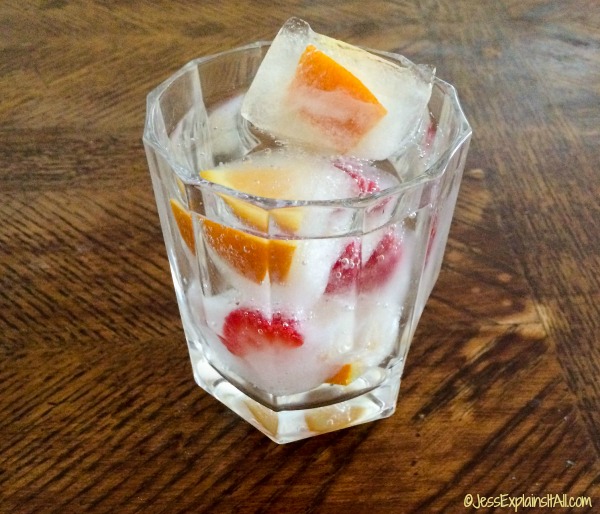 A glass tumbler filled with fancy ice cubes.