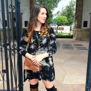Brunette girl wearing a black tie dye dress.