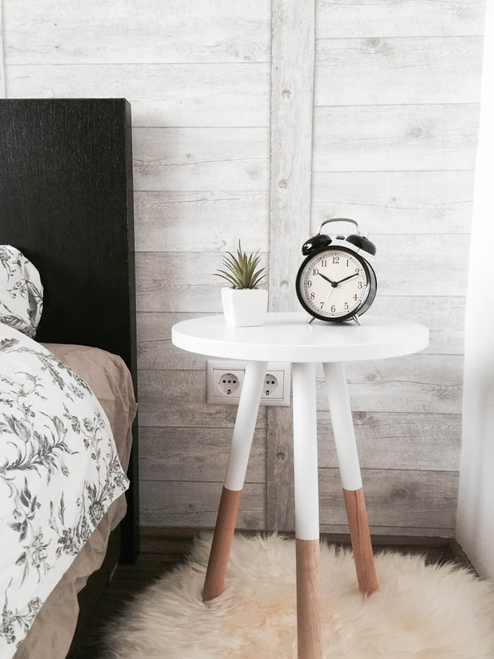 An alarm clock on a bedside table.